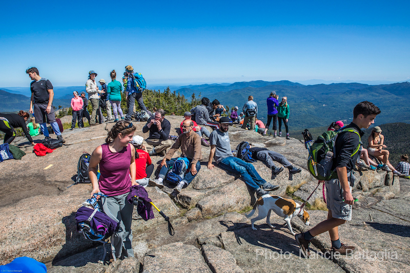 Hikers cover the summit of an Adirondack High Peak